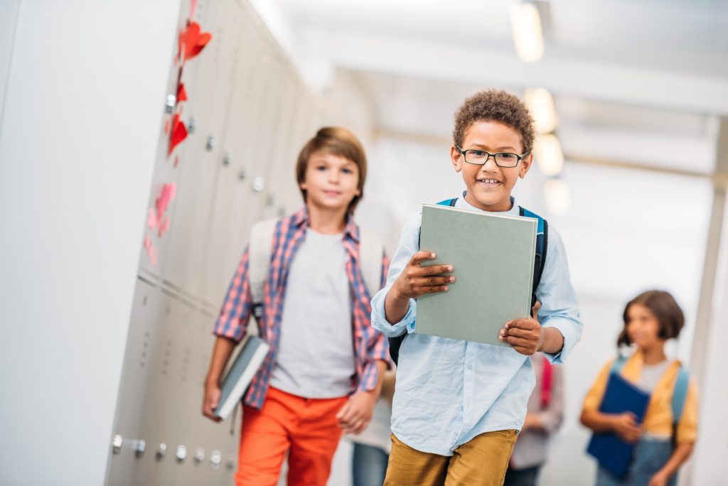 cute elementary kids with books at school